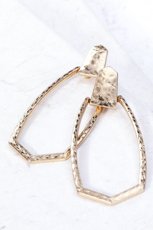 Hammered gold geometric statement earrings.